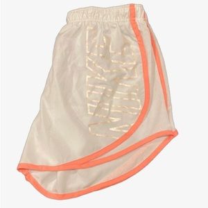 White and pink/orange Nike athletic shorts